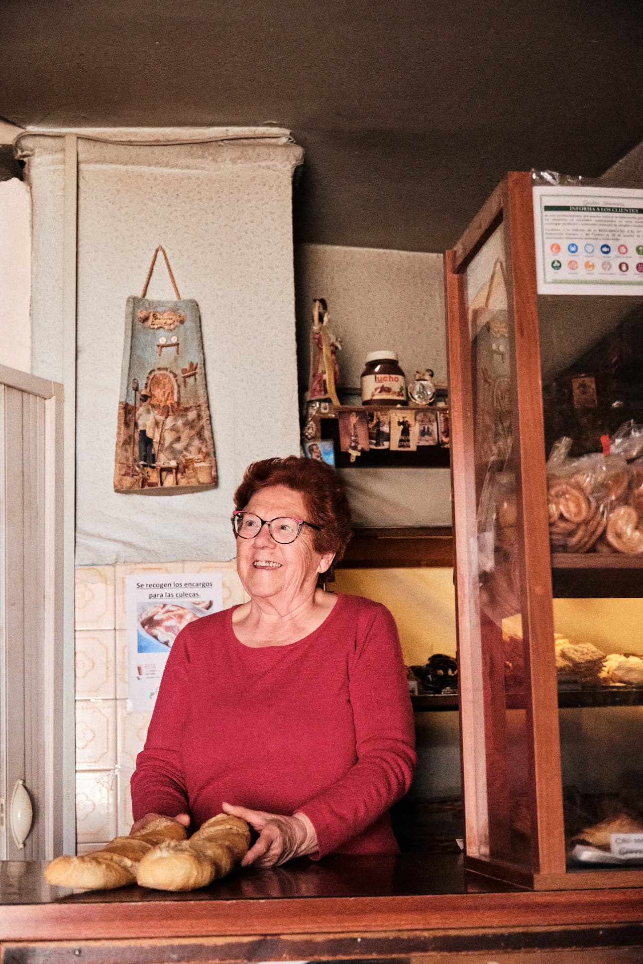 Panadera tras el mostrador de su tienda
